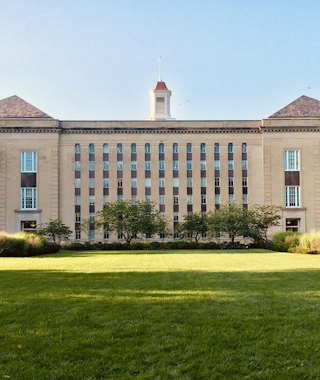 A university building with a lawn in front